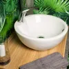 A bathroom sink with a tropical-themed wallpaper. Produktbild-Vorschau