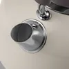 A close-up view of a cream-colored kettle's spout and a chrome handle attachment. Voir les images du produit