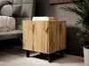 A modern wooden nightstand with black legs is placed next to a chair and a potted plant in a room. Náhled obrázku produktu