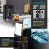 A modern kitchen counter with a black electric kettle, a glass of tea, and a diagram illustrating the kettle's double-wall construction. Produktbild-Vorschau