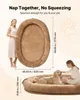 A woman and a dog are shown on a large, oval pet bed. Dimensions are provided. Produktbild-Vorschau