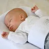 A baby sleeping in a bed. Anteprima dell’immagine prodotto