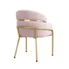 A pink velvet armchair with gold metal legs and accents, shown from a side-rear angle against a white background. Produktbild-Vorschau