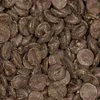 A close-up, overhead view of many dark chocolate chips. Podgląd zdjęcia produktu