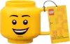 A yellow LEGO head-shaped mug with a tag attached to the handle. Produktbild-Vorschau