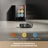 A robotic vacuum cleaner and its accessories are displayed on a floor, with a cleaning station in the background. Produktbild-Vorschau