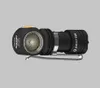 A black Armytek Wizard C1 Pro flashlight with a yellow button and silver clip, set against a plain gray background. Produktbild-Vorschau