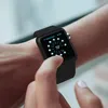 A person's arm wearing a black smartwatch with a weather app displayed on the screen. Produktbild-Vorschau