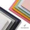 A stack of colorful fabric swatches or samples, arranged diagonally. Produktbild-Vorschau
