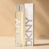 A bottle of DKNY Women Energizing 2011 Eau de Parfum and its packaging are displayed on a light-colored surface against a textured background. Produktbild-Vorschau