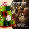 An advent calendar with numbered boxes is shown in the foreground, with a grandfather and child in the background looking at a Christmas tree. Produktbild-Vorschau