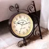 A double-sided antique-style station clock mounted on a decorative stand. Produktbild-Vorschau