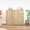 A wooden sideboard with drawers and doors, placed in a room with a sofa and a plant. Anteprima dell’immagine prodotto