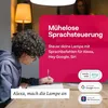 A young person is writing in a notebook while a lamp is visible in the background. Text overlays highlight smart home features. Produktbild-Vorschau