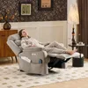 A woman relaxing in a gray recliner chair in a living room. Náhľad obrázku produktu