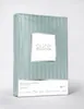 A folded package of bedding with a striped pattern and a label. Náhled obrázku produktu