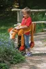 A young boy wearing a horse costume walks outdoors near some flowers. Anteprima dell’immagine prodotto
