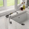 A kitchen faucet is shown in a modern kitchen setting, next to a sink and a window. Produktbild-Vorschau