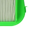 Close-up of a green plastic frame containing pleated white filter material. Produktbild-Vorschau