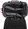 The back of a travel backpack is shown attached to the handle of a rolling suitcase. Produktbild-Vorschau