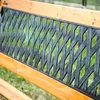 Close-up of a wooden garden bench with a decorative metal backrest. Podgląd zdjęcia produktu
