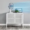 A white fan is placed on a white cabinet, with blue air currents emanating from the fan, suggesting airflow. Náhľad obrázku produktu