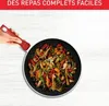 A hand holding a red pan handle, with a stir-fry dish in the pan. Anteprima dell’immagine prodotto