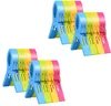 Four sets of colorful plastic clips arranged in two rows. Produktbild-Vorschau