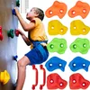 A young boy is climbing a colorful indoor climbing wall with various grips. Voir les images du produit