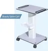 A white beauty salon cart with a gray top and base, on a light blue and white background. Náhled obrázku produktu