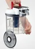 A hand is holding the top part of a transparent vacuum cleaner dustbin, showing the filter inside. Anteprima dell’immagine prodotto