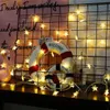 A string of star-shaped fairy lights draped around a decorative lifebuoy and a flamingo figurine. Náhled obrázku produktu
