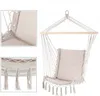 A hanging chair with a cushion, suspended from a wooden bar. Produktbild-Vorschau
