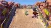 Characters from Mario Party Superstars are racing down a dirt track in a desert environment. Produktbild-Vorschau