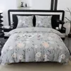 A bed with floral bedding and pillows. Produktbild-Vorschau