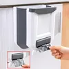 A foldable trash can is mounted on a cabinet door, with a hand pulling out a trash bag. Náhľad obrázku produktu