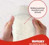 Hands holding a baby diaper with a red circle overlay highlighting text. Náhľad obrázku produktu