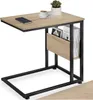 A side view of a C-shaped side table with a wood-grain top and black metal frame, featuring a magazine rack and a small plant and coffee cup on top. Produktbild-Vorschau