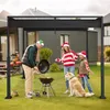 A family with a dog is having a barbecue in their backyard under a black pergola during the Christmas season. Náhled obrázku produktu