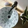 A decorative sink with a mandala pattern on a wooden countertop, next to a plant. Náhled obrázku produktu