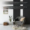 A modern living room scene with a chair, a small table, and wall art, featuring promotional text about sustainable materials and a healthy room climate. Produktbild-Vorschau