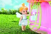 A fairy doll stands next to a pink playhouse in a grassy outdoor setting. Produktbild-Vorschau