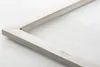 A close-up view of a metal frame on a light-colored surface. Produktbild-Vorschau