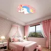 A child's bedroom with a bed, curtains, and a unicorn-shaped ceiling lamp. Produktbild-Vorschau