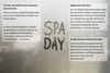 A textured background with text boxes and the words "SPA DAY" written in a stylized font. Produktbild-Vorschau