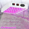 A white LED grow light with pink LEDs is suspended over rows of green plants in what appears to be a greenhouse or indoor grow operation. Produktbild-Vorschau