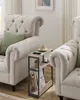 A narrow side table with integrated charging ports is placed between two upholstered chairs in a living room setting. Produktbild-Vorschau