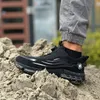 A person wearing black work shoes stands on a pile of dirt. Voir les images du produit