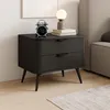 A black nightstand with two drawers, a digital alarm clock, and a lamp on top, placed next to a bed. Náhled obrázku produktu