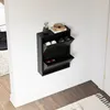 A black shoe cabinet mounted on a white wall. Produktbild-Vorschau